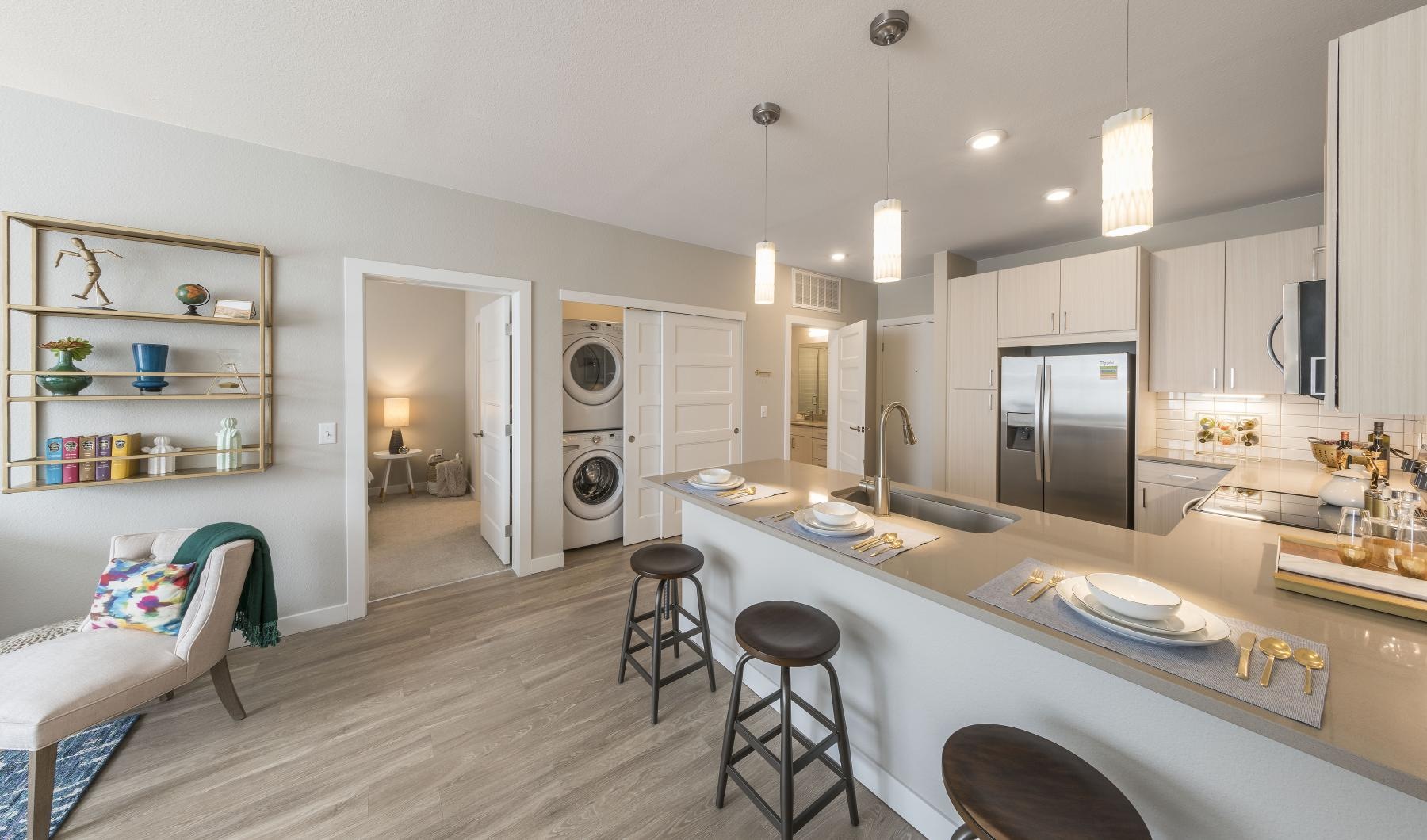 a kitchen with a bar and stools