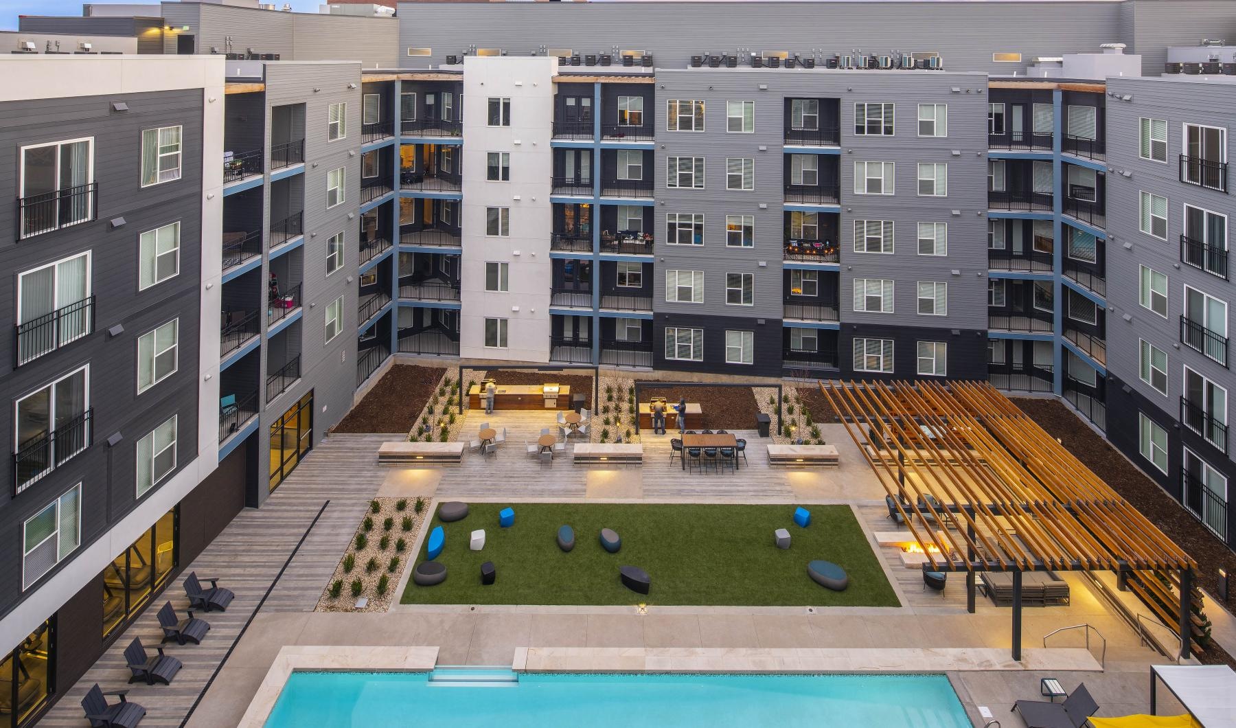 Sparkling swimming pool a courtyard with a pool and buildings around it