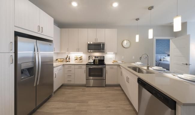 Settle into comfort at Beacon 85 Apartments a kitchen with white cabinets