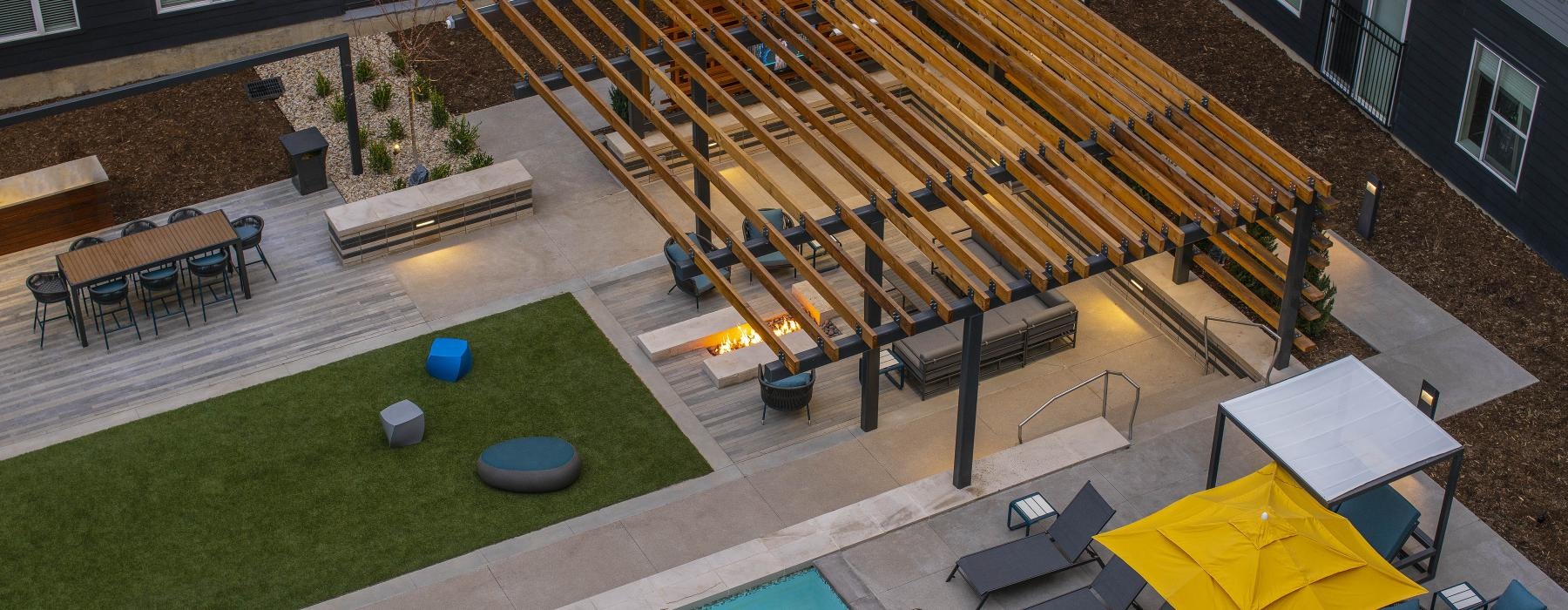 a backyard with a pool and chairs