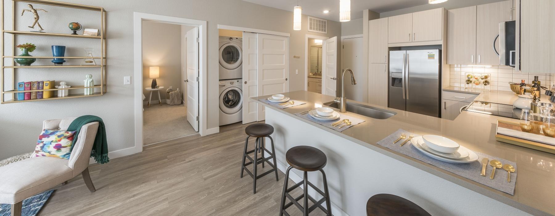 a kitchen with a bar and stools